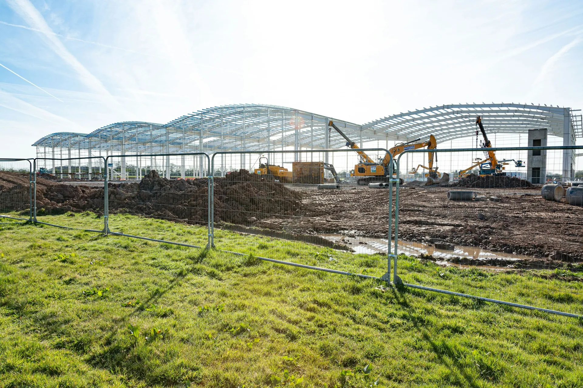 Steel framing and excavators at a large building construction site